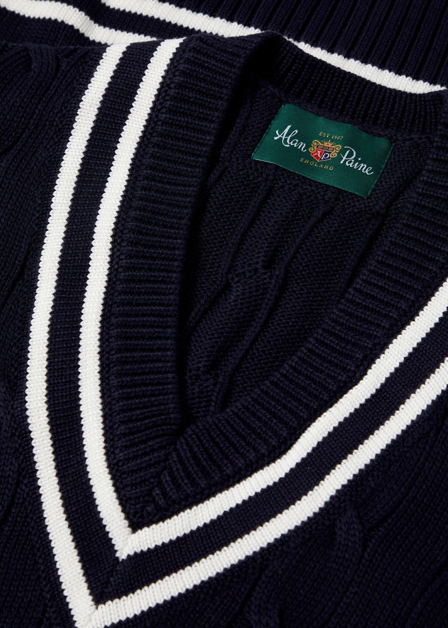 Men's cable knit cricket slipover in dark navy with an ecru trim