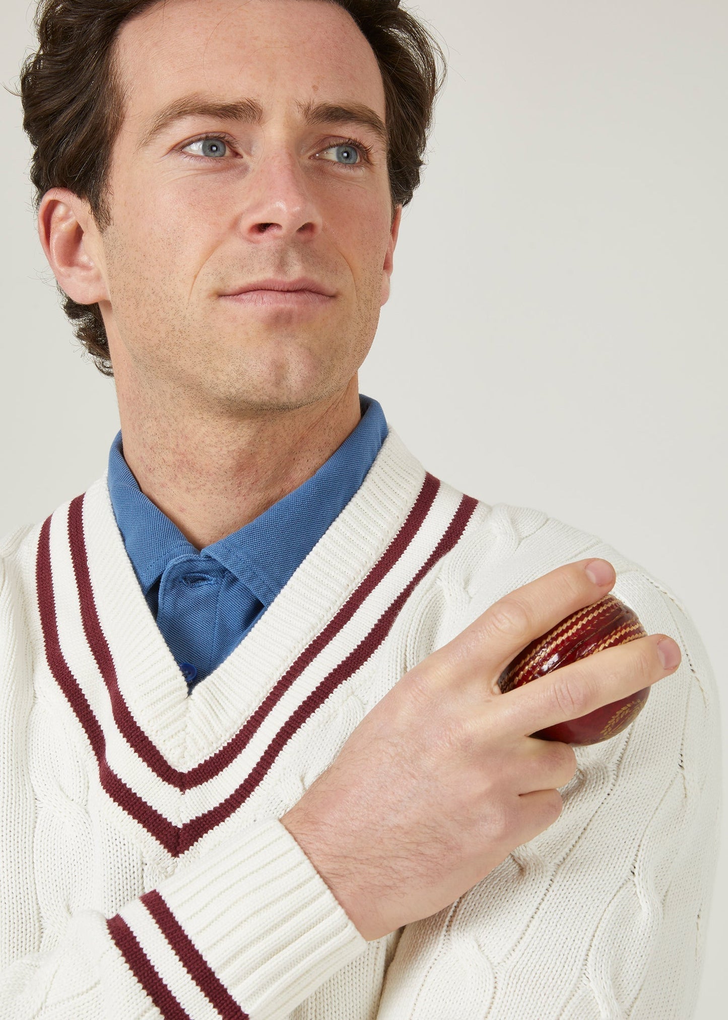 Ecru cricket jumper with a claret red trim and cable knit design.